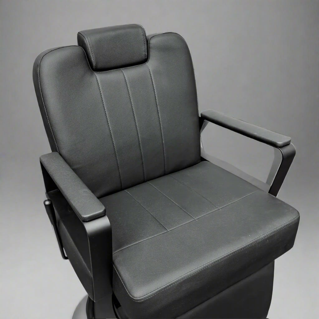 Gray leather airplane seat with armrests on a white background
